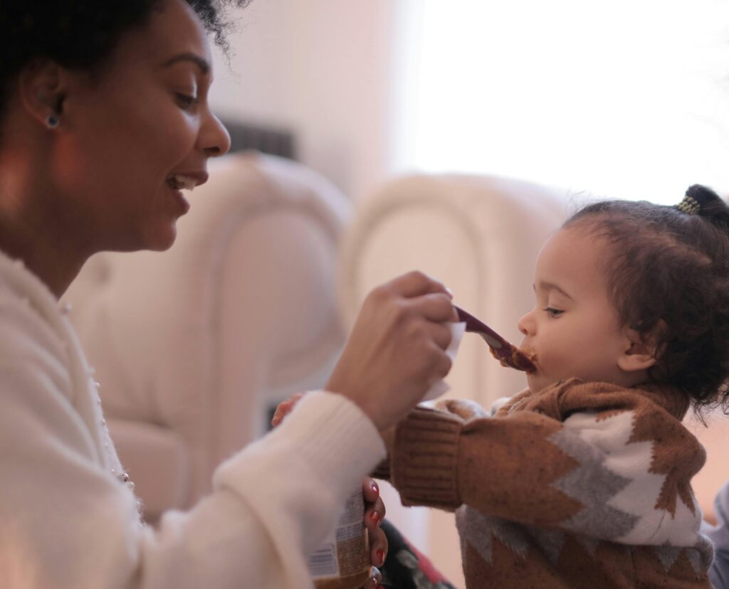 A heartwarming scene of a mother feeding her baby, showcasing love and nourishment.